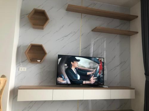 a tv sitting on a shelf in a wall at Khu phố Water Front in Hai Phong