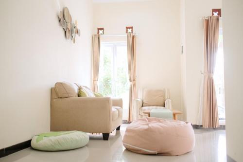 a living room with a couch and a chair at Kays Homestay Jogja in Ngemplak