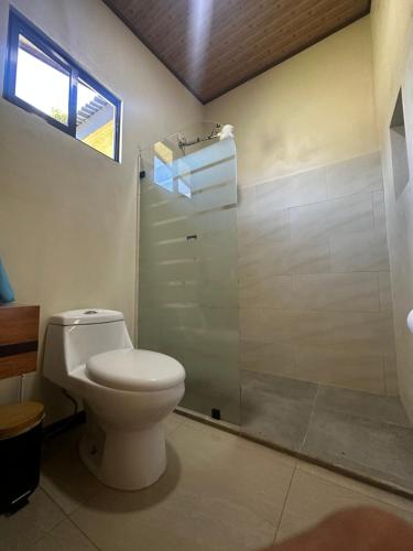 a bathroom with a toilet and a shower at Modern Loft inside a beautiful farm in General Viejo