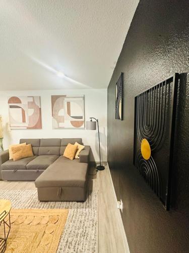 a living room with a couch and a table at Trendy Midtown Apartment in Houston