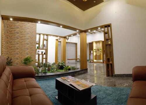 a living room with a couch and a table at Casa Royal HomeStay in Kattappana