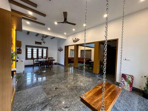 a swing in a room with a living room at Casa Royal HomeStay in Kattappana