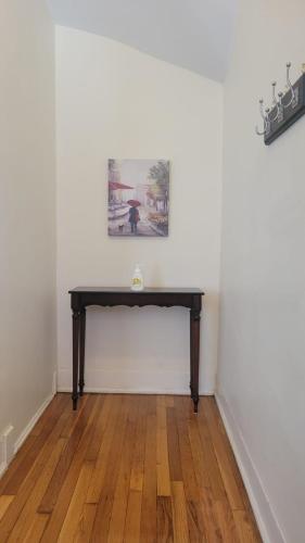 a table in a room with a white wall at Chateau de Woodlawn - Room II - Le Parisienne in Chicago