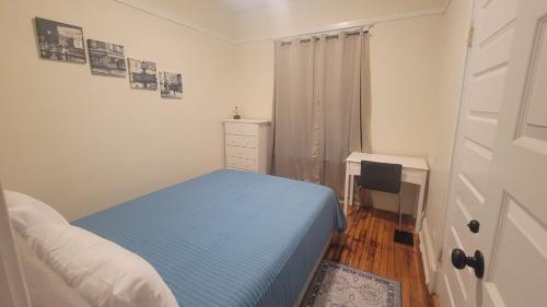 a small bedroom with a bed and a desk at Chateau de Woodlawn - Room II - Le Parisienne in Chicago