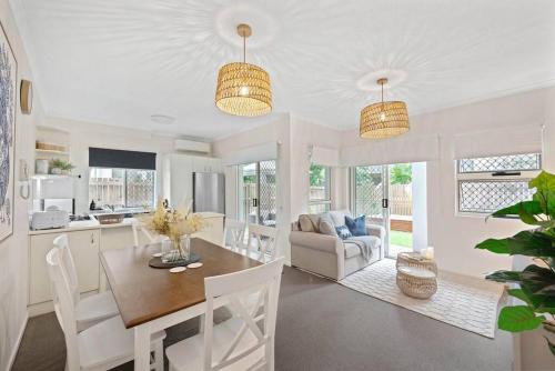 a kitchen and living room with a table and chairs at Contemporary Comfy ~ 2Bed/2Bath/1Car ~ Hawthorne in Brisbane