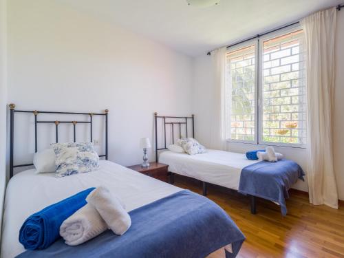 a bedroom with two beds and a window at El Jardin de Santa Brígida with private pool, sauna & jacuzzi in Santa Brígida