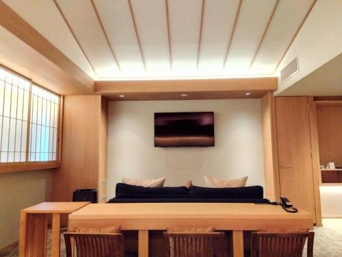 a living room with a table and a couch at KAYA Kyoto Nijo Castle, BW Signature Collection by Best Western in Kyoto
