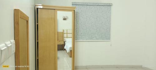 an open door to a bedroom with a bed at فندق رفال الغربية للشقق المخدومة in Ukaz