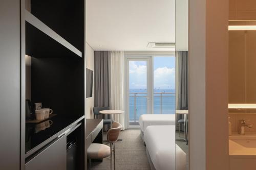 a hotel room with a view of the ocean at Urbanstay Busan songdo Beach in Busan
