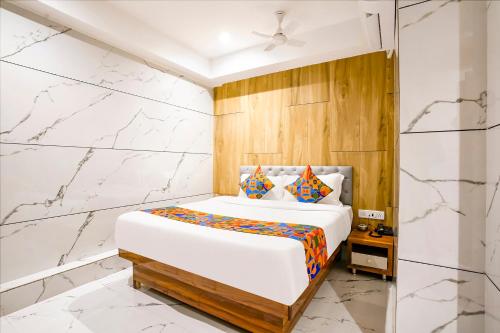 A bed or beds in a room at FabHotel Shubham Inn