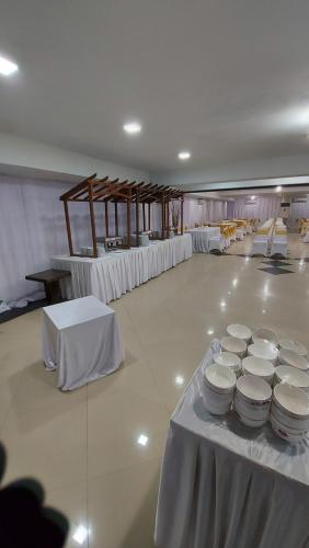 einen Bankettsaal mit weißen Tischen und weißer Bettwäsche in der Unterkunft GRAND DARUSSALAM HOTEL in Medan
