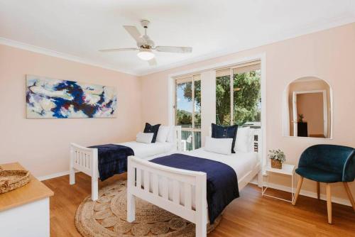 a bedroom with two beds and a window at Macquarie Manor - Experience Grand Country Living in Mudgee