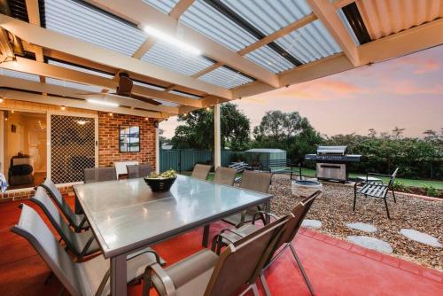 a patio with a table and chairs and a grill at Macquarie Manor - Experience Grand Country Living in Mudgee