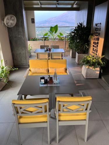 a table and chairs with a view of the ocean at Distrikt 9 in Palakkad