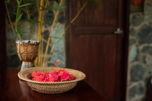 a basket of flowers sitting on a table with a vase at Kiao Beach in Anepahan