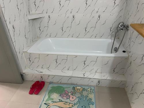 a white bath tub in a bathroom with a rug at Rockville Abode in Iringa
