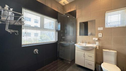 a bathroom with a sink and a toilet at Anchor Bay Workation in Cape Town