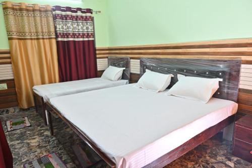 מיטה או מיטות בחדר ב-Vaidehi Home Stay