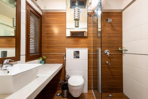 a bathroom with a toilet and a sink and a shower at Hotel 91 Golf Course Road in Gurgaon