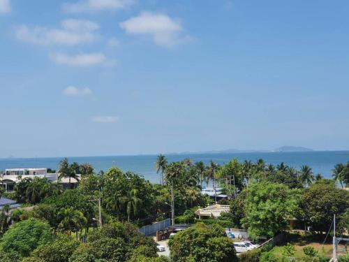 an aerial view of a resort with trees and the ocean at The Blu X Bangsaen F5 R51 in Ban Bang Saen (1)