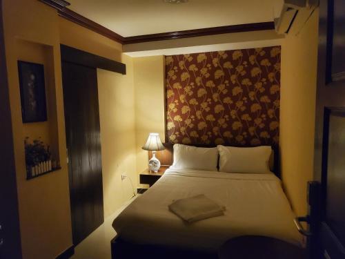 a hotel room with a bed with a head board at The Pattaya Sports Hub in Pattaya Central