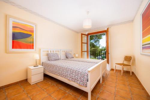 a bedroom with a white bed and a window at Cala Pi One in Cala Pi