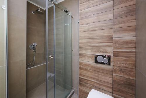 a shower with a glass door in a bathroom at Apartment in the heart of the city in Athens