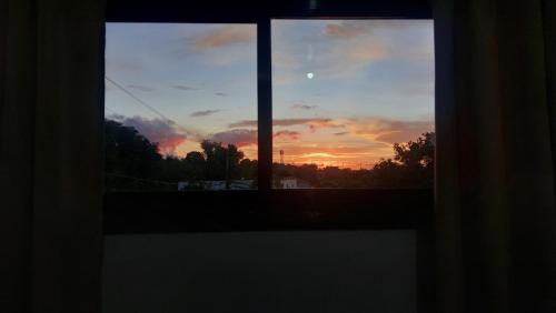una vista desde una ventana de puesta de sol en Chico's Spacious and Private Two-Storey Home, en Zamboanga