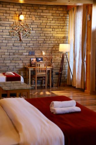 a bedroom with a bed with two towels on it at Kasar Himalaya Holiday Resort, Binsar Rd in Almora