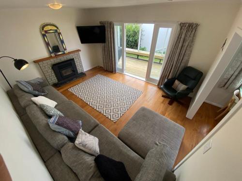 a living room with a couch and a fireplace at Rotorua Forest Getaway in Rotorua