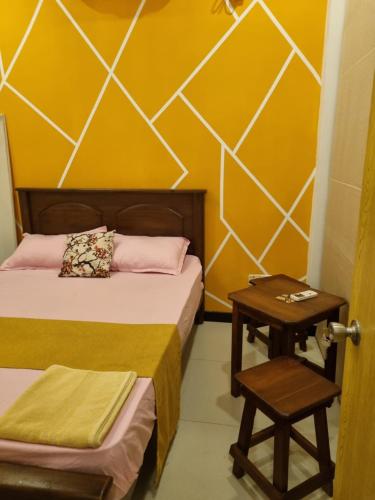 a room with two beds and a table and a door at River Front Villa in Wadduwa