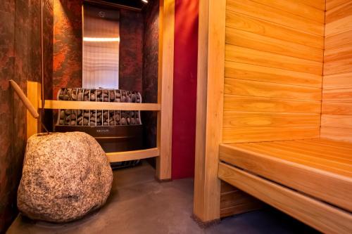 a sauna with a rock sitting in a room at Miyazaki Daiichi Hotel in Miyazaki