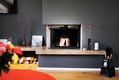 a living room with a fireplace in a room at Strandhaus in Hörnum