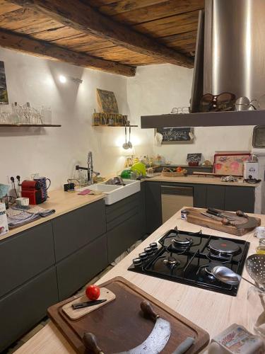 a kitchen with a stove and a counter top at Maison de village de 1802, fraîchement rénovée à Beauvezer 04370 in Beauvezer