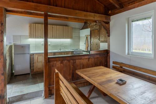 a kitchen with a wooden table and a refrigerator at Holiday Home Lanita with Two Bedrooms & Terrace in Podbočje