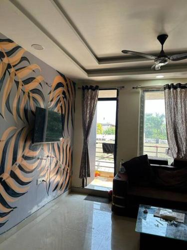 a living room with a couch and a window at Sukh sagar Lifestyle in Jabalpur