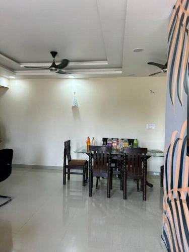 a dining room with a table and chairs and a ceiling at Sukh sagar Lifestyle in Jabalpur