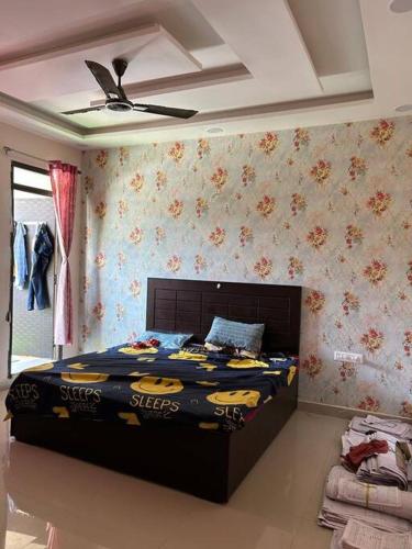 a bedroom with a bed with a batman comforter at Sukh sagar Lifestyle in Jabalpur