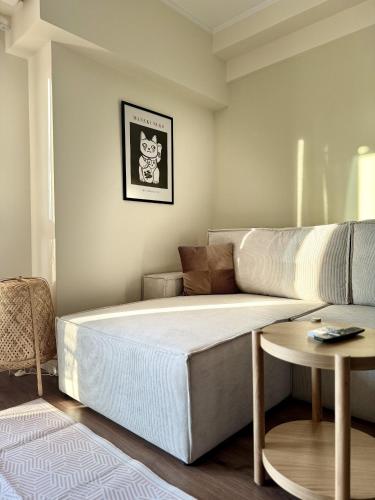 a large bed in a room with a couch at Uddo Apartment in Komotini