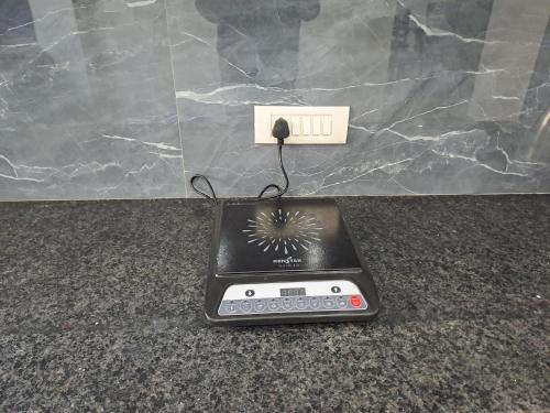 an electronic device plugged into an electrical outlet at Gokul 2 BHK Entire Flat, Bharat City, Teela Mod, Nr Hindon Airport ,Bhopura , Ghaziabad in Ghaziabad