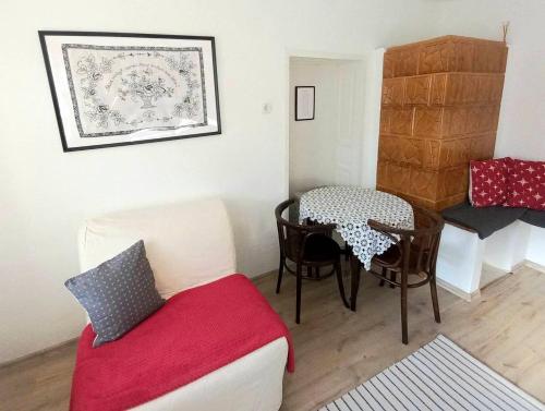 a living room with a table and a couch at Lankás Vendégház - Hollókő in Hollókő