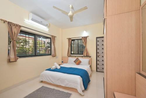 a bedroom with two beds and a window at EMPYREAN STAY ll 2BHK ll LITTLE HOUSE VILLA ll in Lonavala
