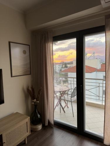 a room with a sliding glass door with a balcony at Uddo Apartment in Komotini
