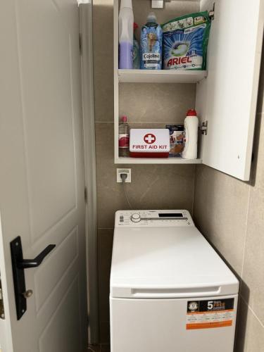 a small kitchen with a washer and dryer at Uddo Apartment in Komotini