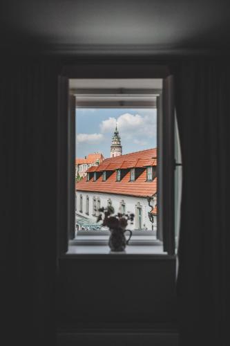 a view of a building through a window at Penzion KOVÁRNA in Český Krumlov