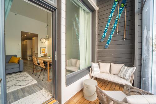a screened porch with a couch and a table at Hilmantori Apartments by Hiekka Booking in Kalajoki