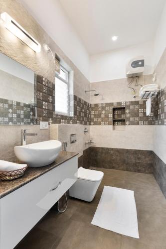 a bathroom with a sink and a toilet and a tub at Tusker Trail by LuxUnlock in Suntikoppa