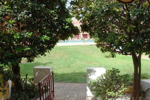 - une vue sur un parc avec une porte et des arbres dans l'établissement Precioso dúplex con piscina, en 1ª linea de playa, à Puerto de Mazarrón