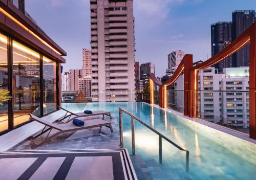 a swimming pool on the roof of a building at SAMALA Hotel Bangkok in Bangkok