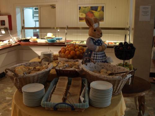a table with baskets of fruit and a stuffed rabbit at Hotel la Palmera & Spa in Lloret de Mar